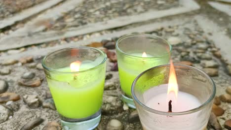 close-up-of-three-candles-on-the-floor