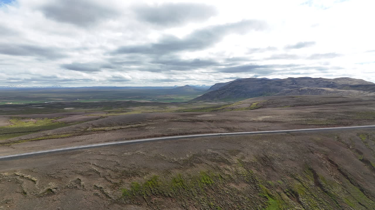 Aerial view of the highland landscape in Langanesbyggð, Iceland, showing rugged terrain, rolling hills, and wide open natural scenery