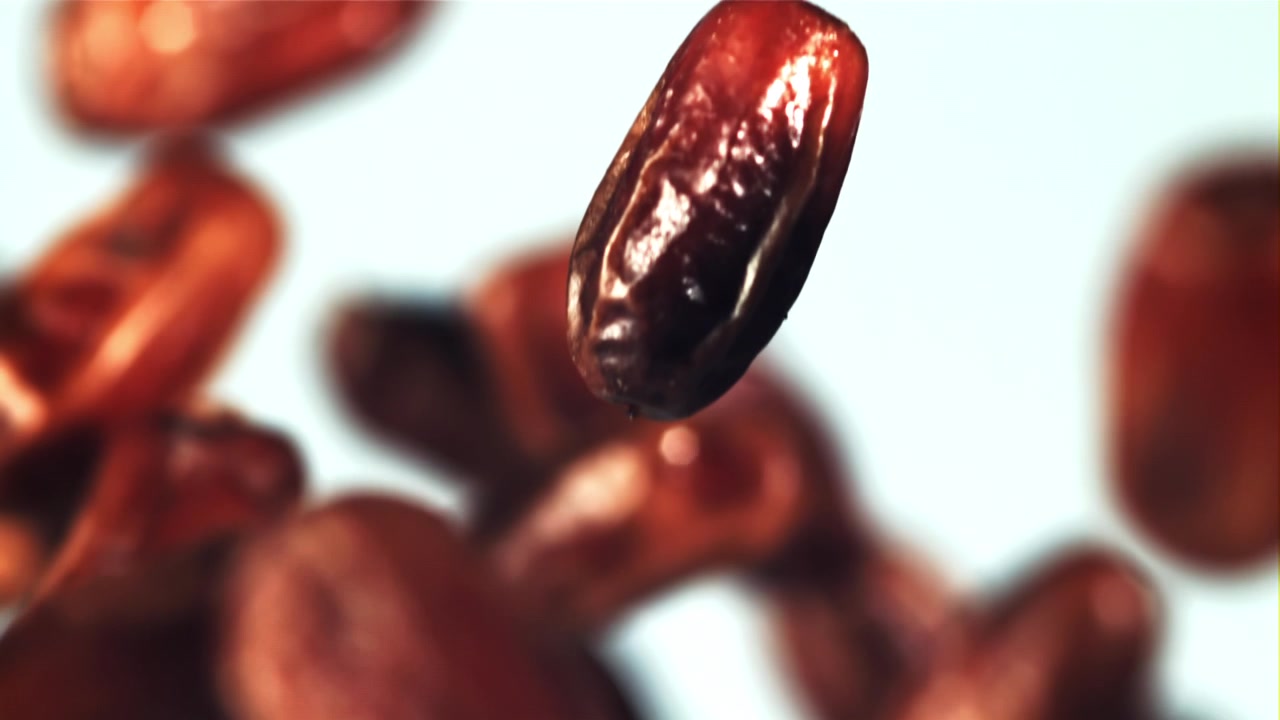 Macro Shot of a Fresh Date Fruit Falling in Slow Motion