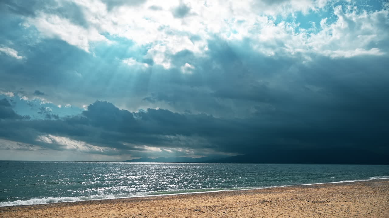 Aegean sea coast in Greece. Wind, cloudy sky, godrays, waves
