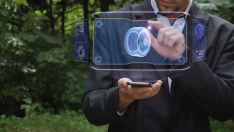 Businessman uses hologram with car wheel