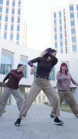 dancing crew performing energetic street dance routine outdoors