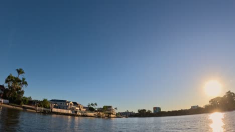 sunset view over waterfront buildings and palm trees