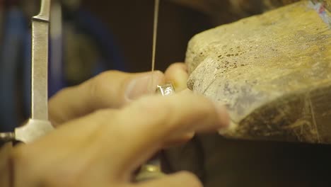 italian goldsmith at work building an engagement or a wedding ring