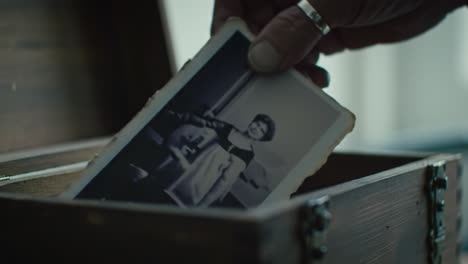 a person uncovers a vintage wooden box revealing a collection of old photographs. each picture tells a unique story, sparking nostalgia and curiosity about the past.