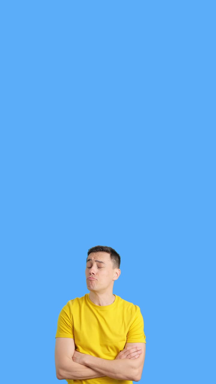 Man in a yellow shirt with a blue background