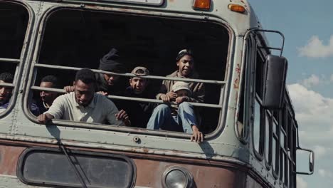 people traveling by overcrowded bus