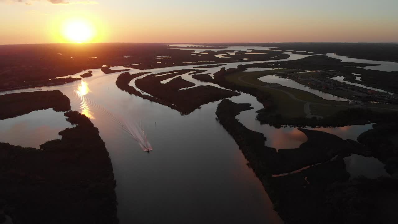 A boat charging down the inlets surrounding the Manatee River at sunset. South Florida, land of recreational dreams