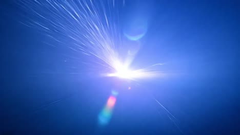 intense laser beam creates vibrant blue sparks in a dynamic burst. ideal for science, technology, and energy themes