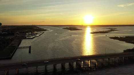 an aerial drone shot over a quiet marshland with a bridge