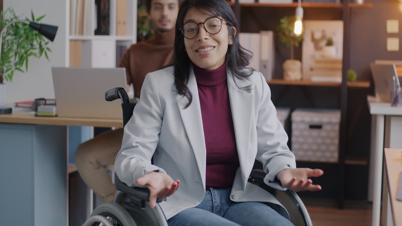Businesswoman in Wheelchair at Office Meeting
