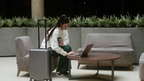 businesswoman using her laptop in the hotel hall