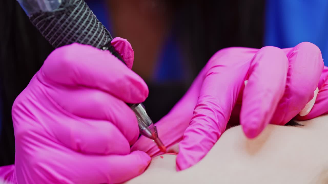 Close up view of cosmetological procedure. Professional tattooist making permanent makeup