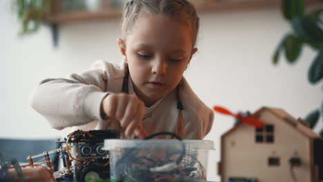 little girl building robots 1