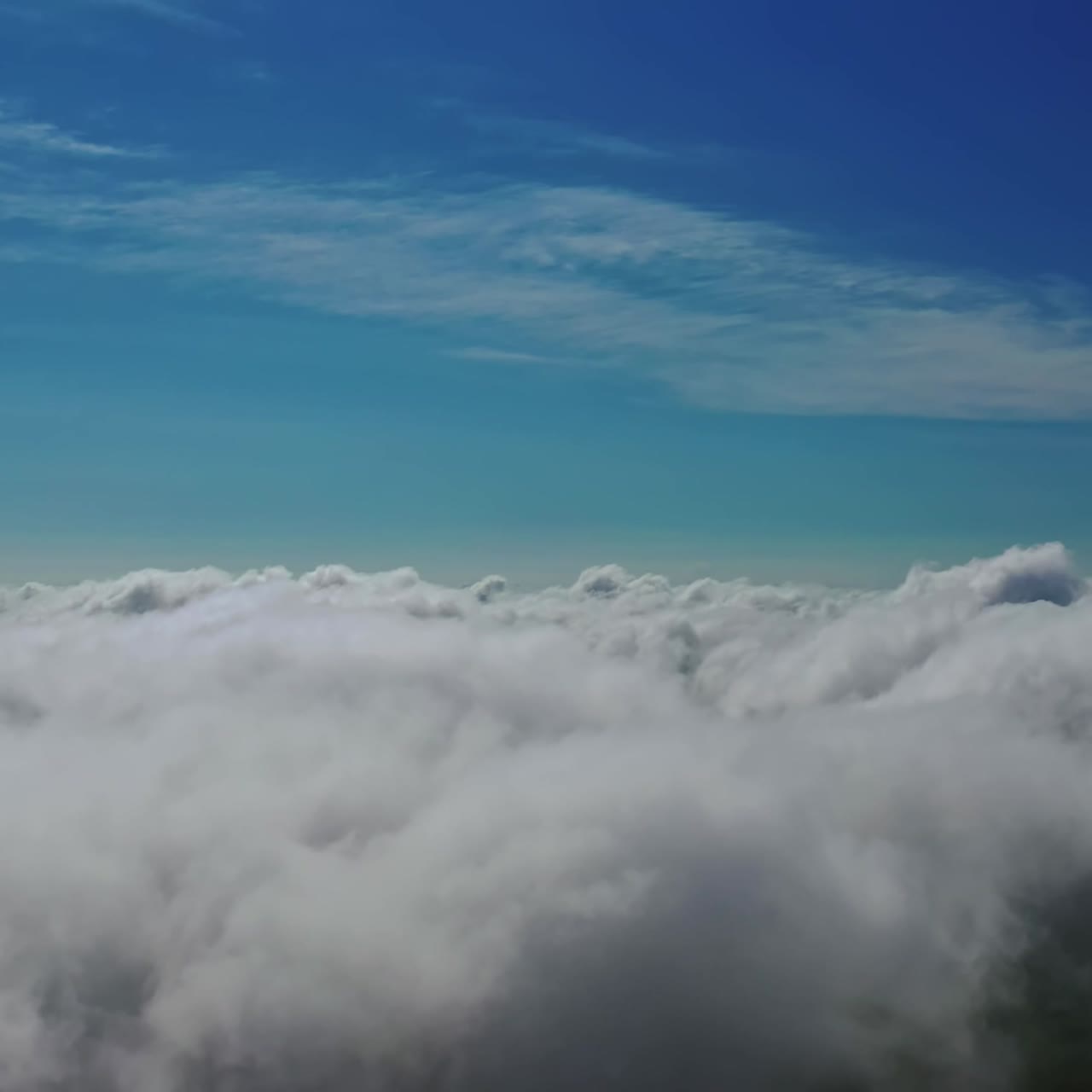 Clouds atmosphere. Flying over white clouds in the sky. Beautiful background of soft clouds moving slowly. Aerial view.
