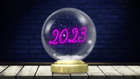 Animation-of-christmas-snow-globe-with-snow-falling-and-2023-text-on-brick-background