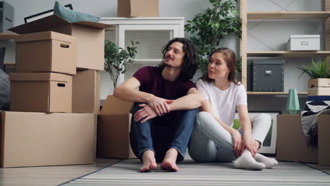 couple sitting together in a newly-moved apartment