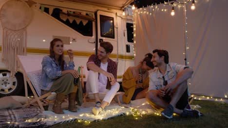 Video-of-smiling-friends-in-front-of-camper.