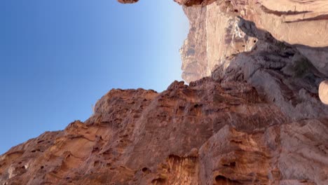 Looking-down-a-canyon-above-Petra,-Jordan---vertical-panorama