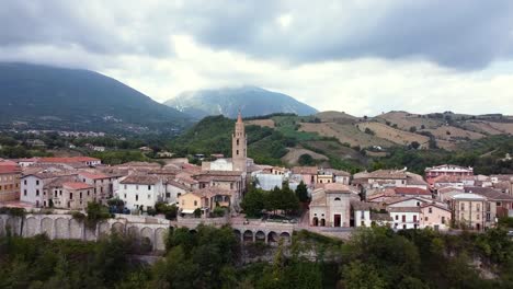 aerial dolly out revealing a small italian town in a mountain landscape