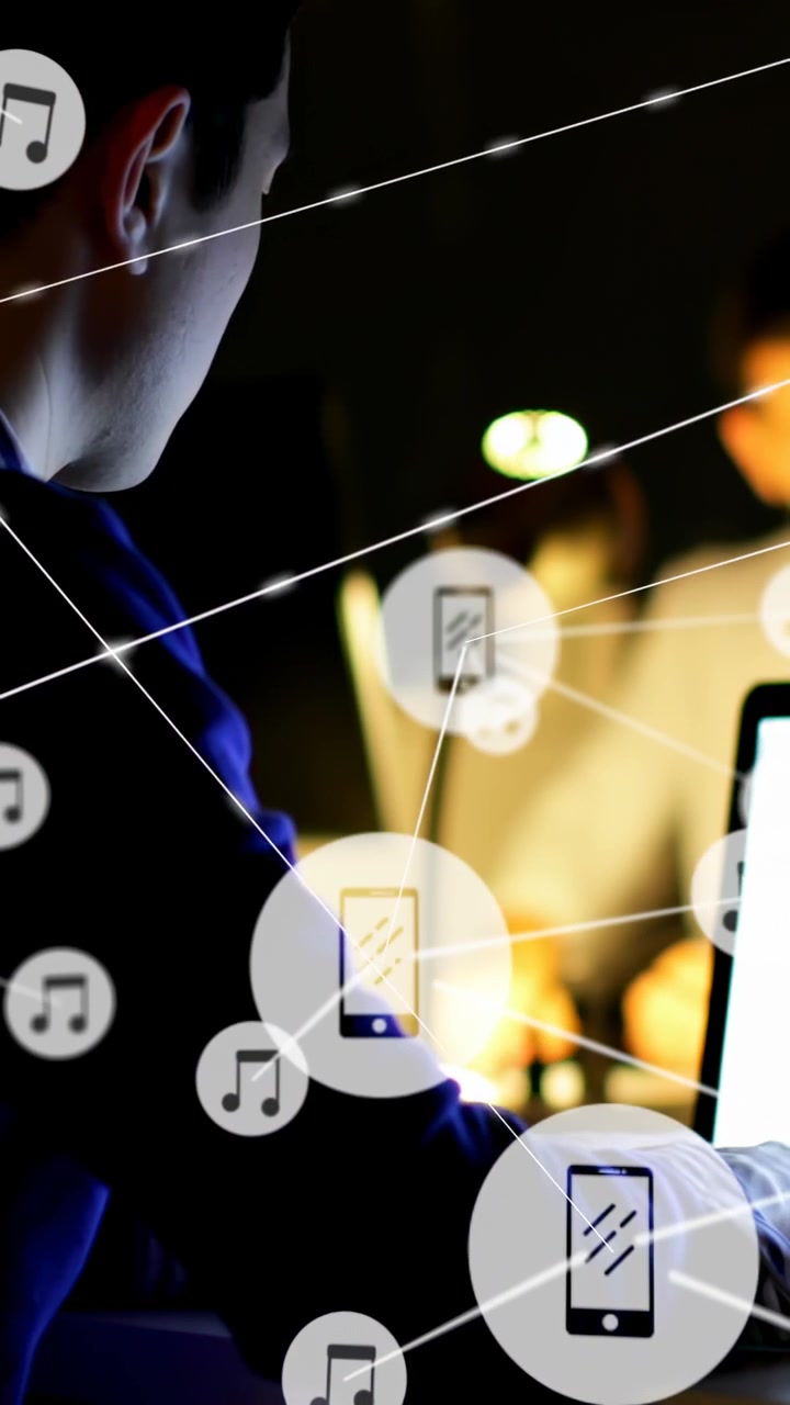 Vertical video: Left man typing at laptop starting tech net, phone music icons growing for teamwork