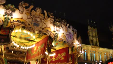 an amusement horse ride spinning around in the christmas markets