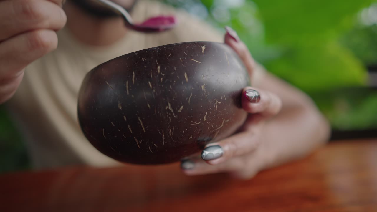 Person Drinking from Coconut Bowl