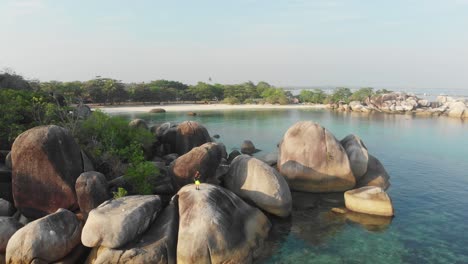 reveal shot of big granite boulders at belitung island indonesia, aerial