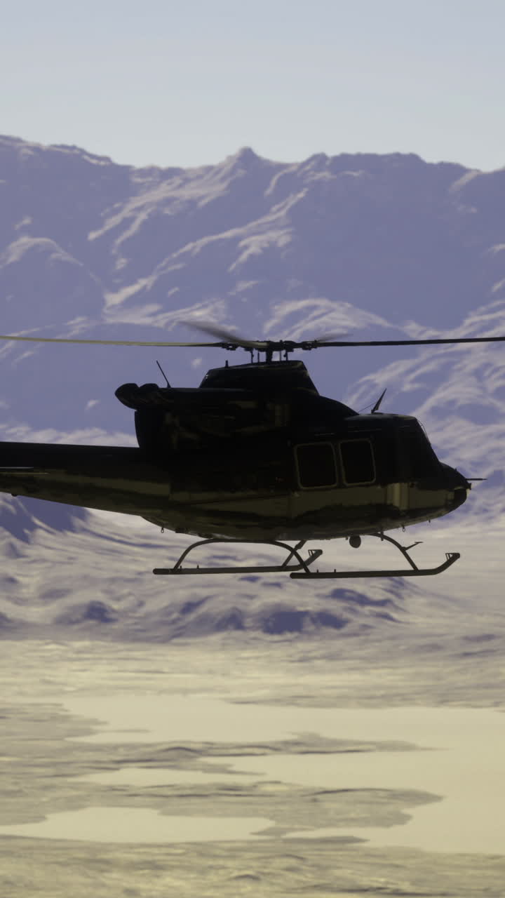 Helicopter flying over arid landscape with mountains in the background