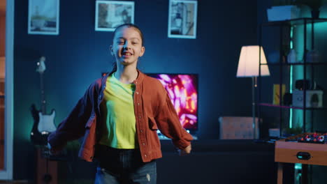 joyful kid recording dancing video for her internet audience on latest viral music