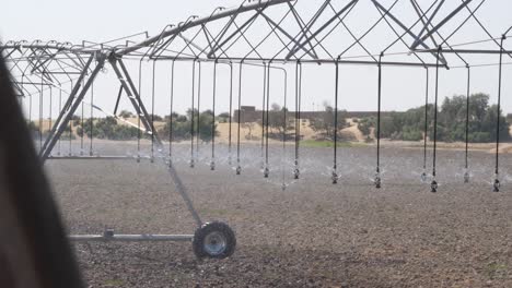 sprinklers on center pivot irrigation system watering field