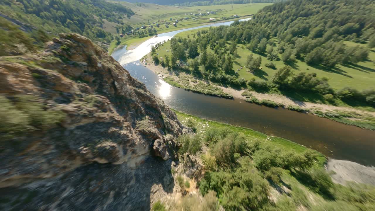 The clean river encircles the island covered with a variety of trees and plants. The glare of the sun on the water. Wild sandy beaches where inflatable boats are located.