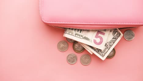 pink purse with money and coins