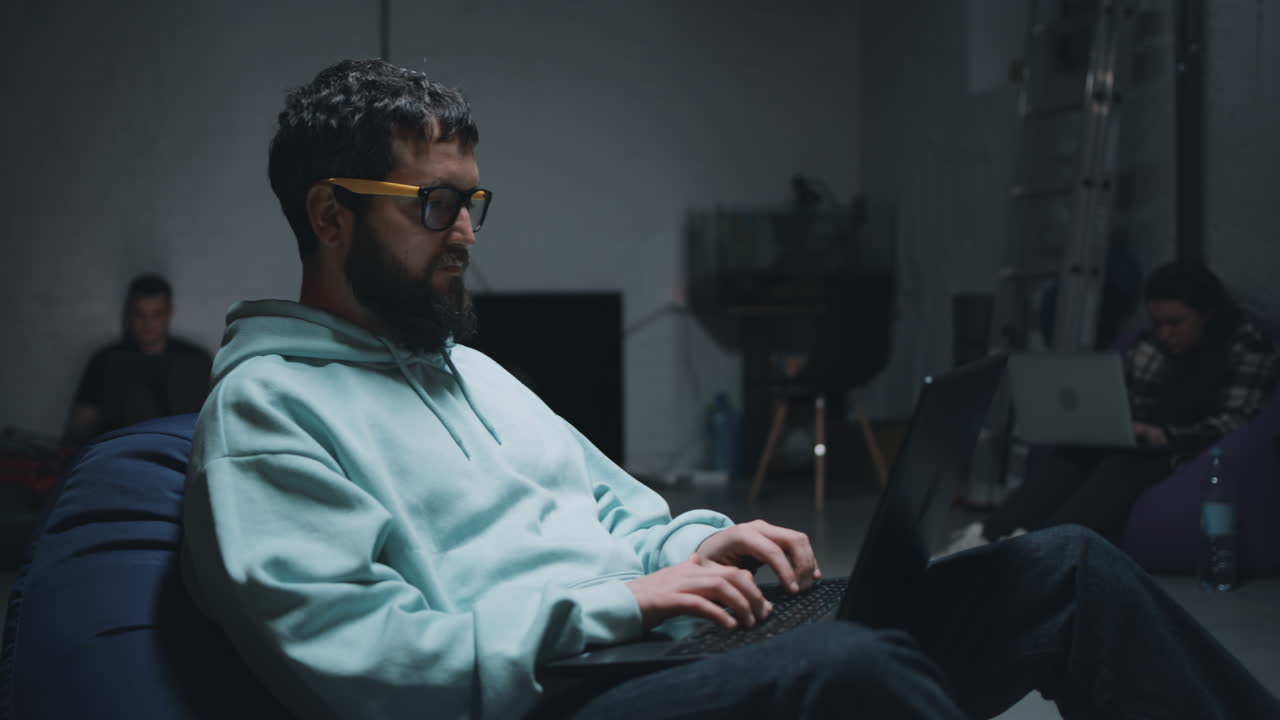 Man Working on Laptop in a Coworking Space