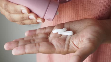 woman applying hand cream