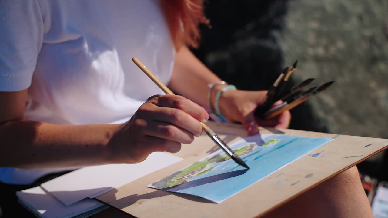 Woman painting outdoors