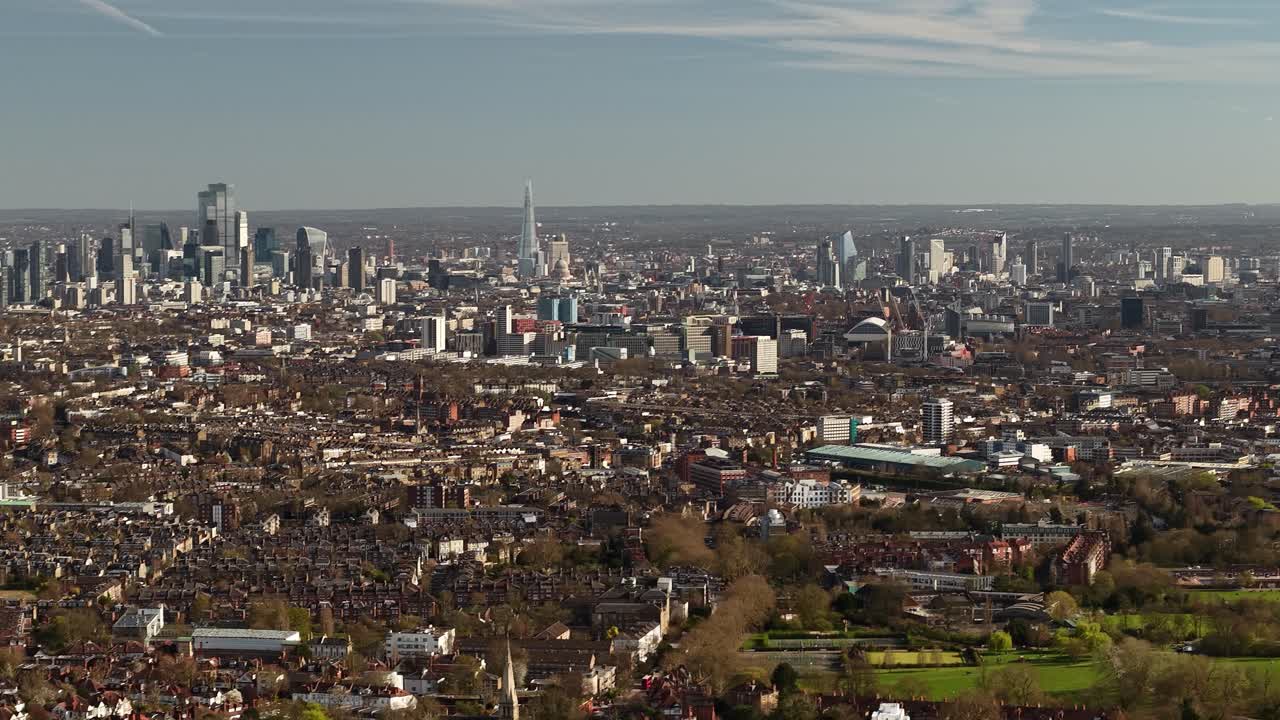 Wide panoramic aerial view dolly across London city landscape and vast surrounding district suburbs