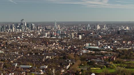 Wide panoramic aerial view dolly across London city landscape and vast surrounding district suburbs