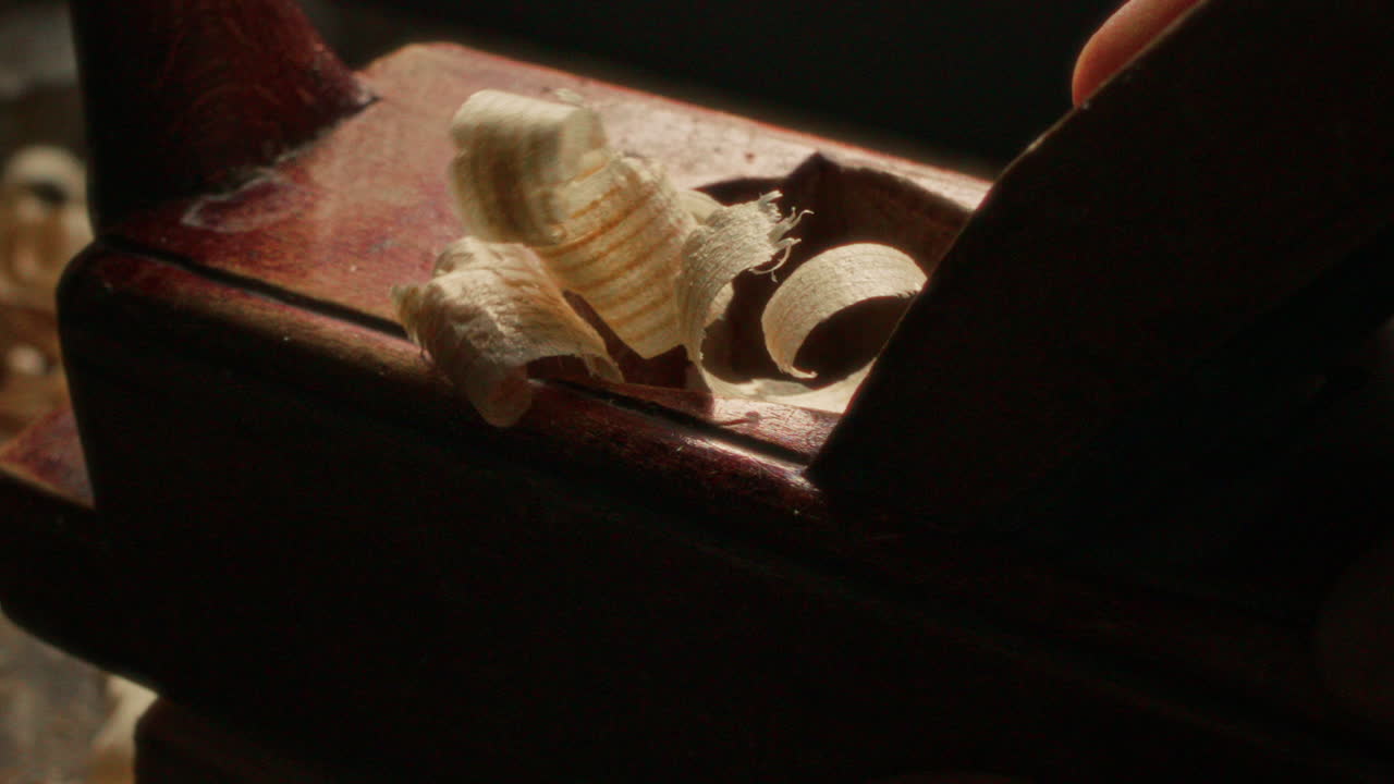 Close Up of Polishing Timber with Hand Planer, Producing Curled Wood Shavings