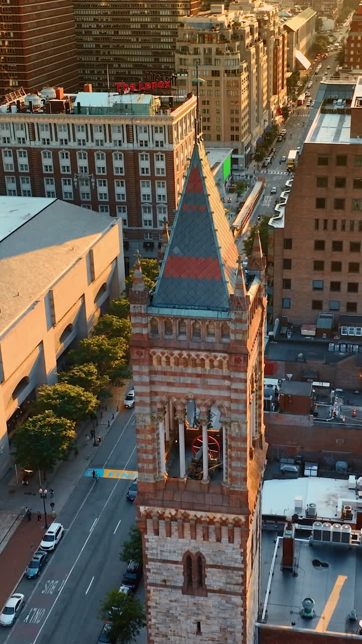 Golden hour in Boston, Massachusetts, USA. Drone flying above the tower of Old South Church.. Vertical video
