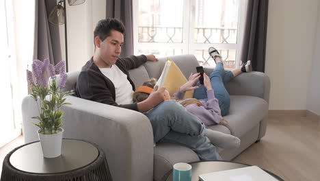 young couple relaxing and spending time together on the couch while staying at home.