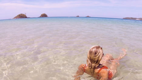 young beautiful woman sits in the crystal clear oceans of nacpan beach in el nido philippines, perfect holiday and dream destination-2