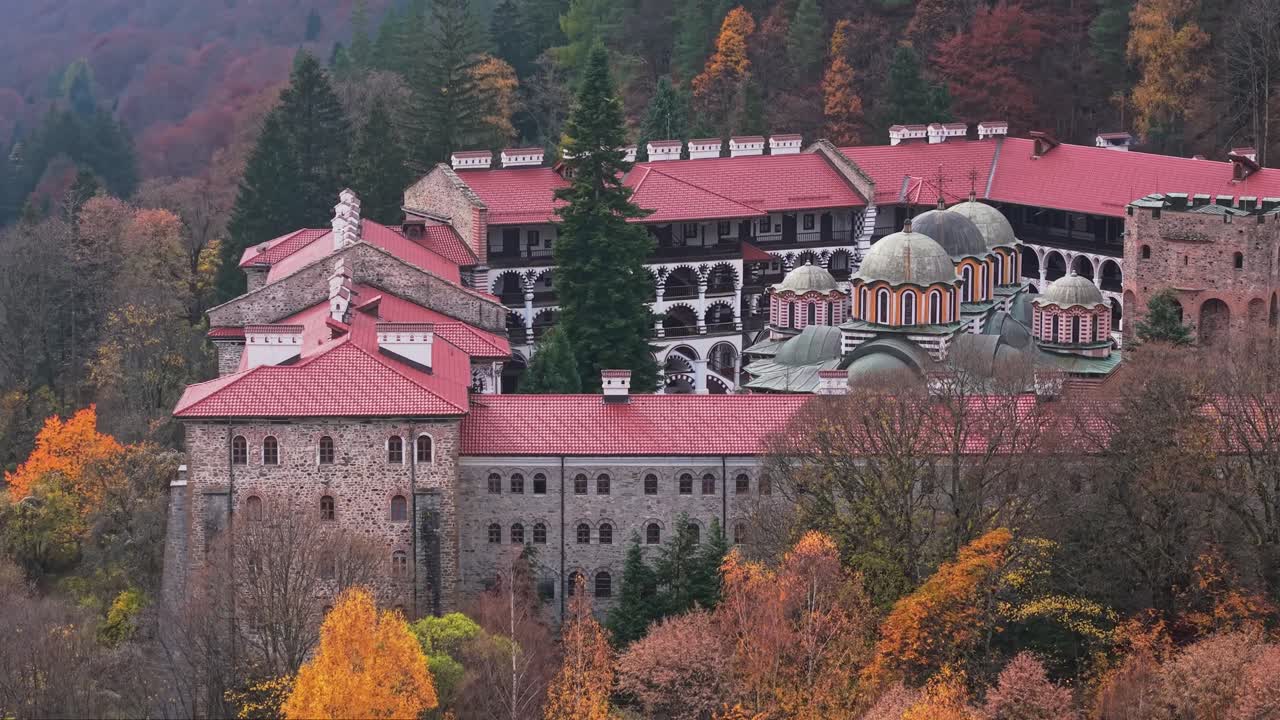 A drone shot slowly rising to reveal the interior of the chapel at Rila Monastery, showcasing architecture and details from above