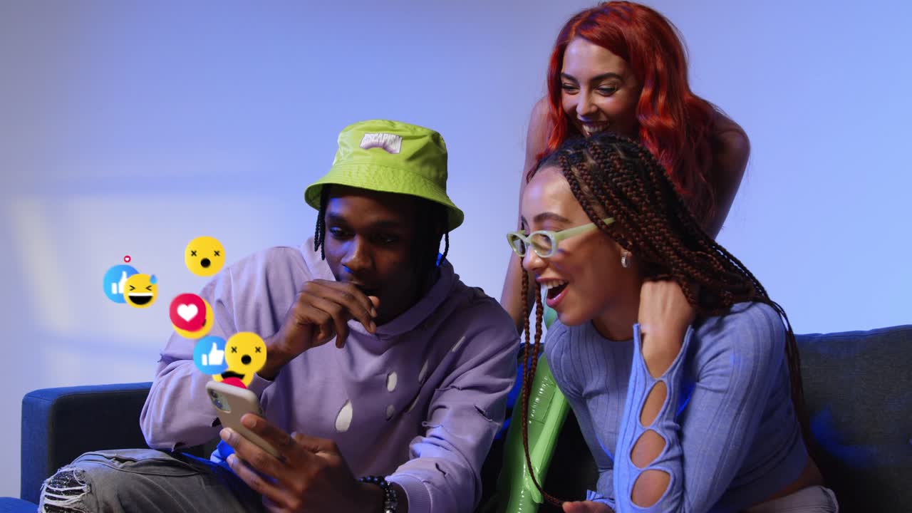 Group Of Gen Z Friends Looking At Mobile Phone With Motion Graphics Emojis Showing Multiple Social Media Notifications Liking And Reacting To Online Content 1