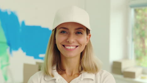 smiling woman in white cap, possibly a painter