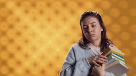 Exhausted-woman-yawning,-holding-heavy-stack-of-books-needed-for-school-exam