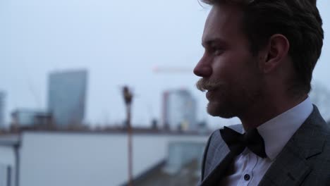 a well suited man smiling and talking to someone
