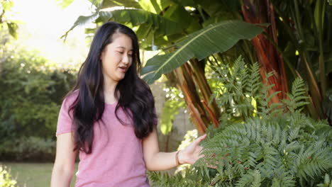 exploring garden, woman enjoying nature and touching plants