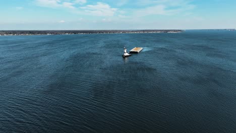 A-tug-boat-and-an-empty-barge-trudging-through-the-lake