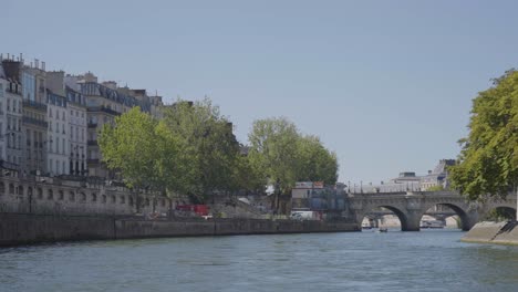 view of city and bridges from tourist boat on river seine in paris france shot in slow motion